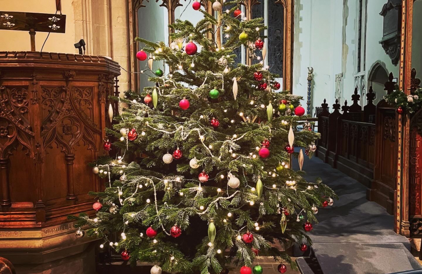 Brightly list Christmas tree inside a church