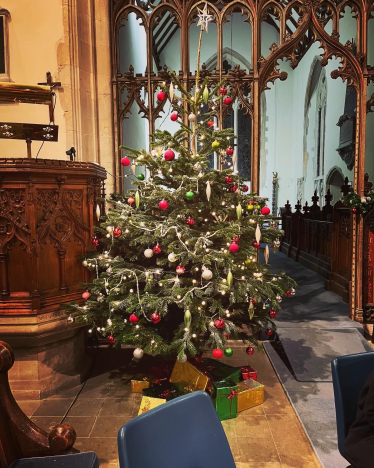 Brightly list Christmas tree inside a church