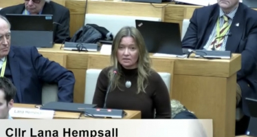 Lana Hempsall sitting in Norfolk County Council meeting speaking in favour of the Level 3 Devolution Deal